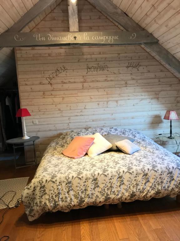 a bedroom with a bed with two pillows on it at AU COEUR DE LA NATURE in Allaire