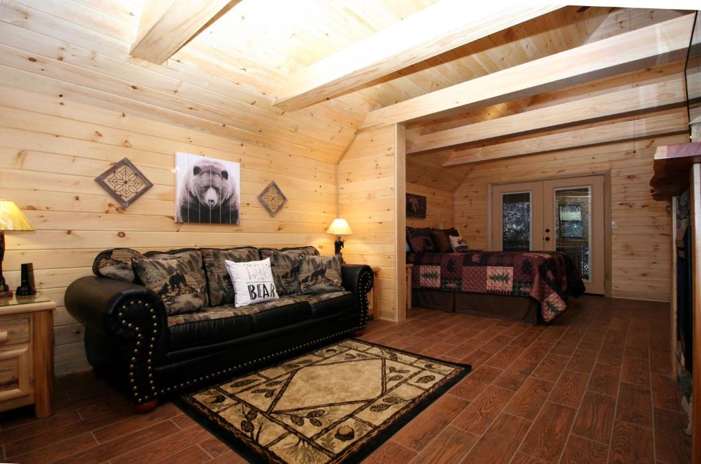 a living room with a couch and a bed at Sweet Memories in Gatlinburg