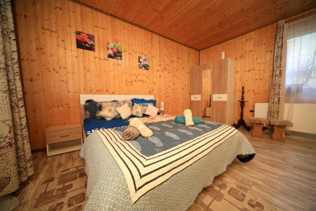 a bedroom with a bed with teddy bears on it at Sforii Residence in Braşov