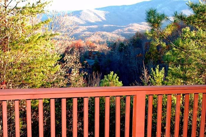 a red bench with a view of a mountain at Mountain Love Nest in Gatlinburg
