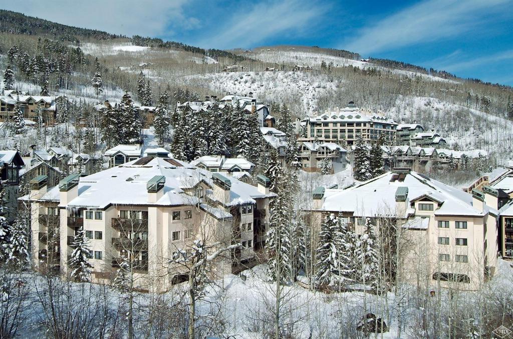 a group of buildings with snow on their roofs at Townsend Place by Vail Realty in Beaver Creek