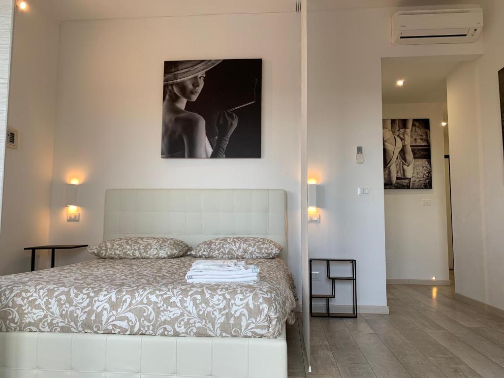 a bedroom with a bed and a picture of a woman at Stayinbologna 3 in Bologna