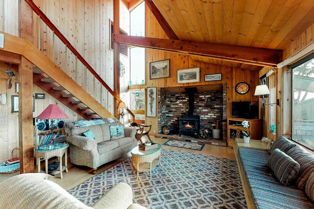 a living room with a couch and a fireplace at Thayer House in Sea Ranch