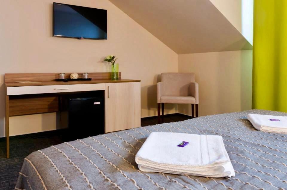 A bed or beds in a room at Penzion Lipa