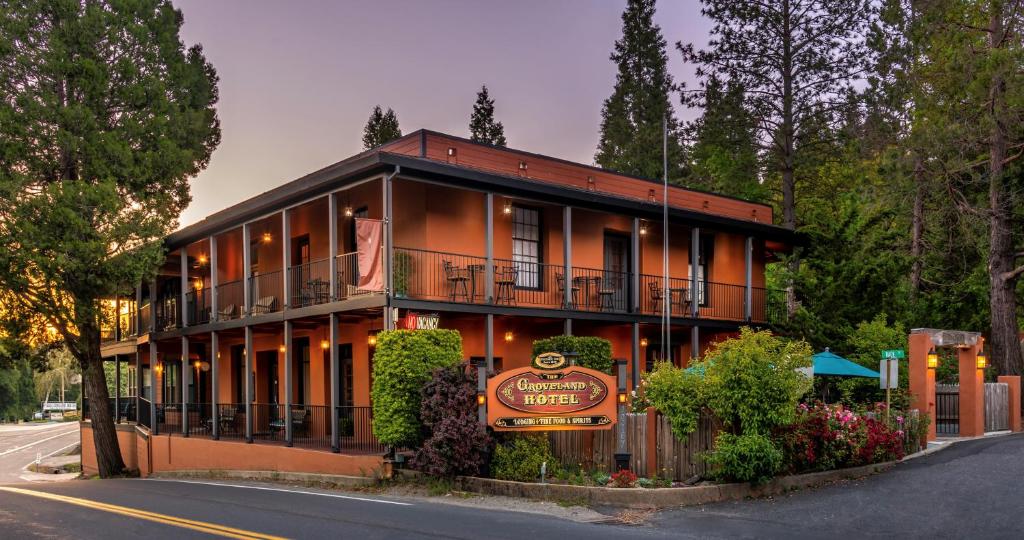 an orange building with a sign in front of it at The Groveland Hotel in Groveland