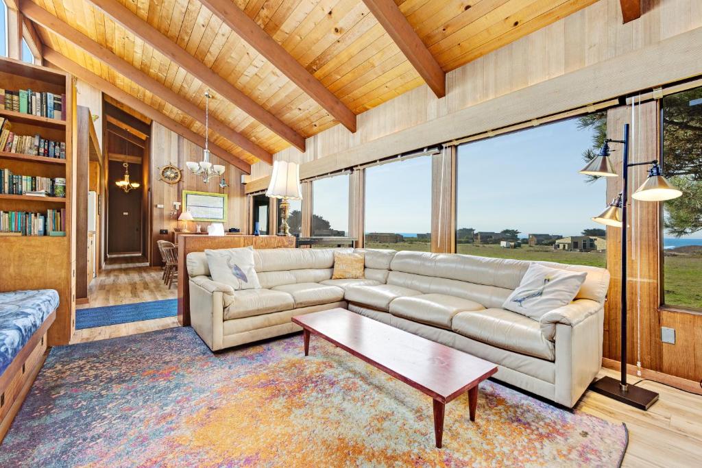 a living room with a couch and a table at Anam Cara in Sea Ranch