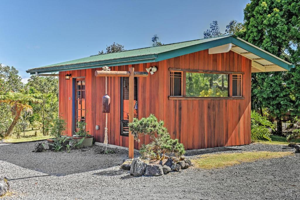 a small red shed with a window and a door at Cozy Volcano Studio with Phenomenal Rainforest Views! in Mountain View