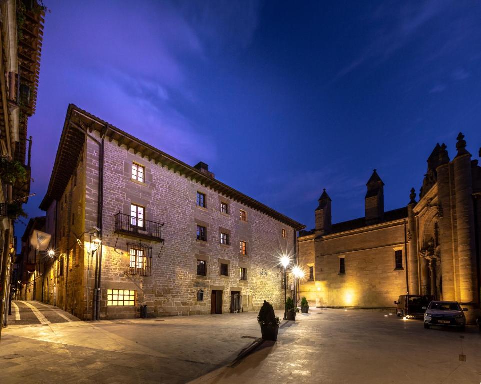 a large stone building at night with at Palacio de Pujadas by MIJ in Viana