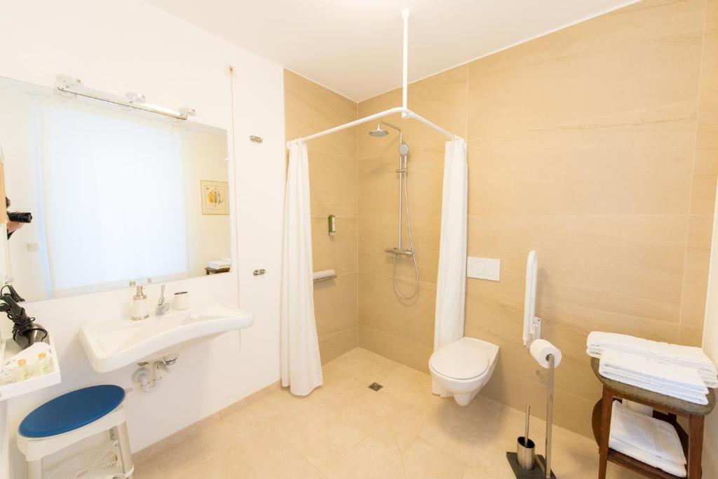 a bathroom with a sink and a toilet and a shower at Berdorfer Eck - Bed&Breakfast in Berdorf