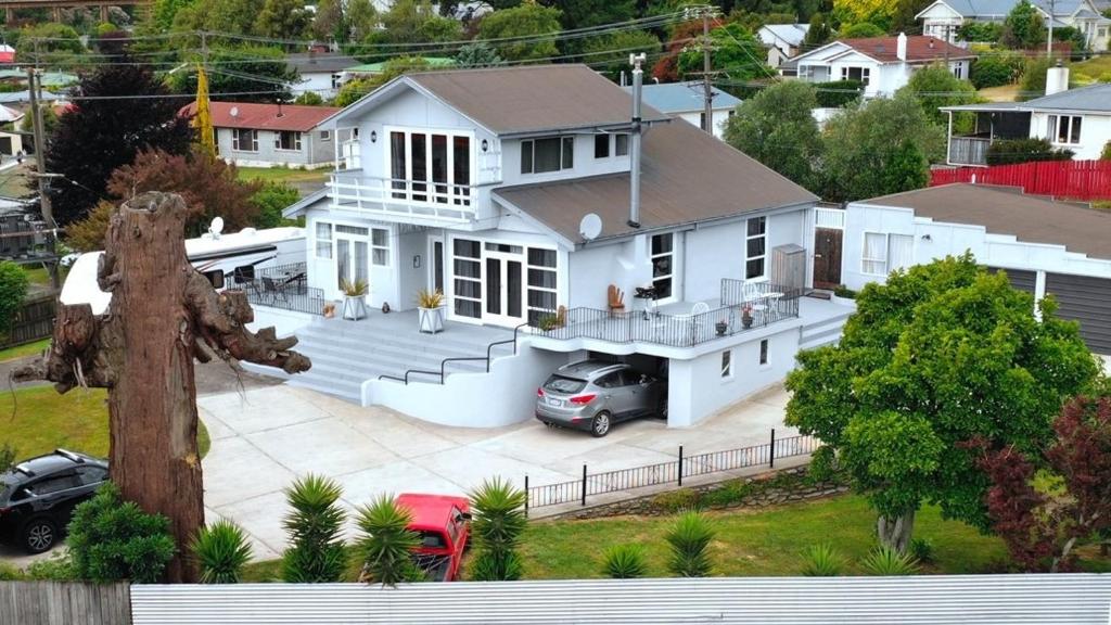 an aerial view of a white house with a driveway at Top of the Town in Picton