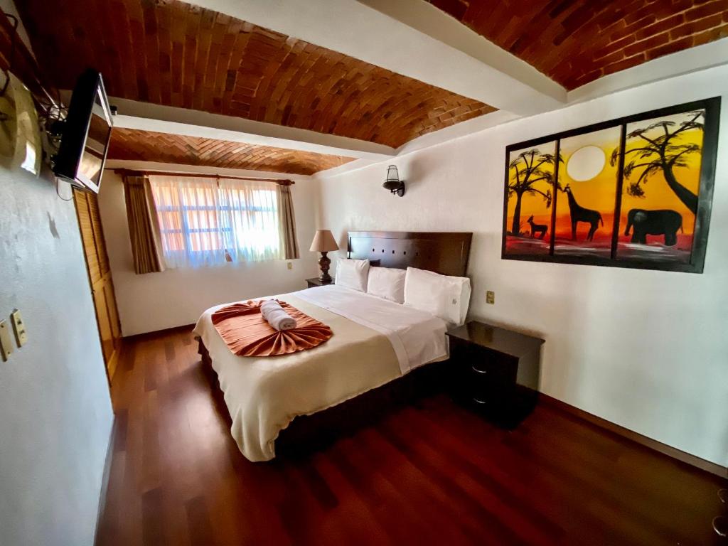 Postel nebo postele na pokoji v ubytování Suites Paraiso Tequis