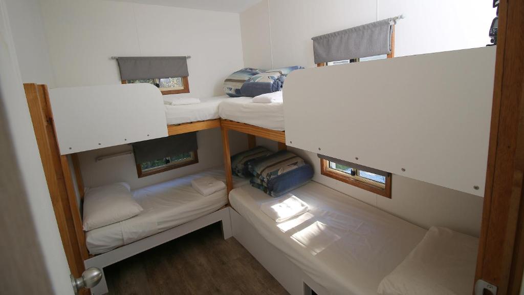 a room with three bunk beds in a room at Beauty Point Tourist Park in Beauty Point