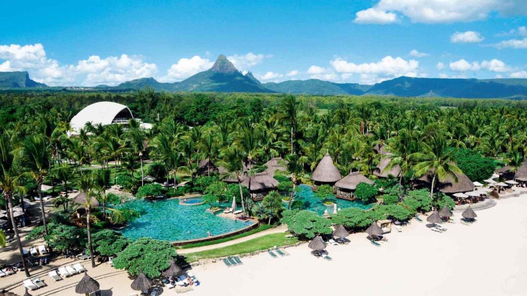 an aerial view of a resort with a pool and palm trees at La Pirogue Mauritius in Flic-en-Flac
