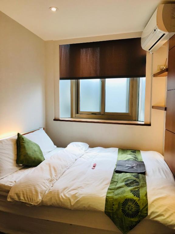 Postel nebo postele na pokoji v ubytování Chiu Chunt Dint B&B