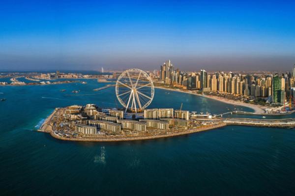 an aerial view of a city with a ferris wheel at Luxury Interior W Sea View - Bluewaters Island in Dubai
