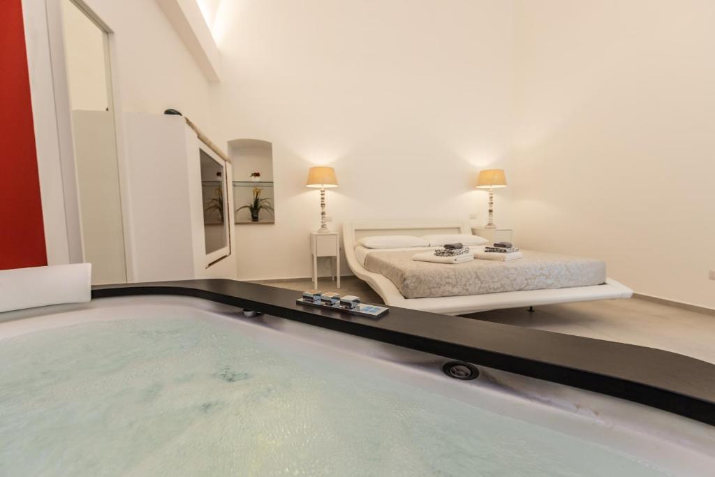 a bedroom with a bed and a swimming pool at Vincent Suite Luxury B&B in Palo del Colle