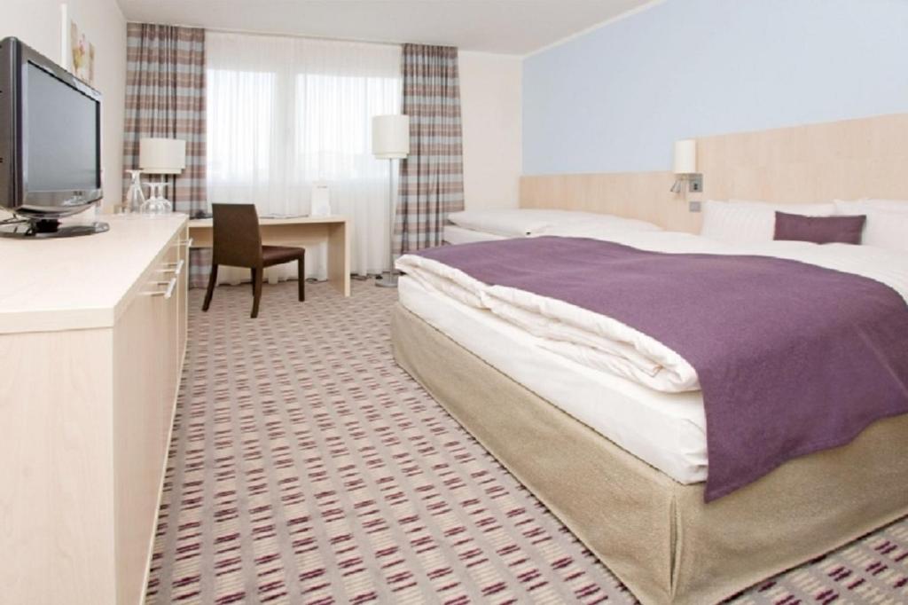 Postel nebo postele na pokoji v ubytování Mercure Hotel Mannheim am Friedensplatz