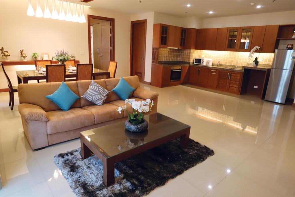 a living room with a couch and a table at Pattaya City Resort by Harmony in Pattaya