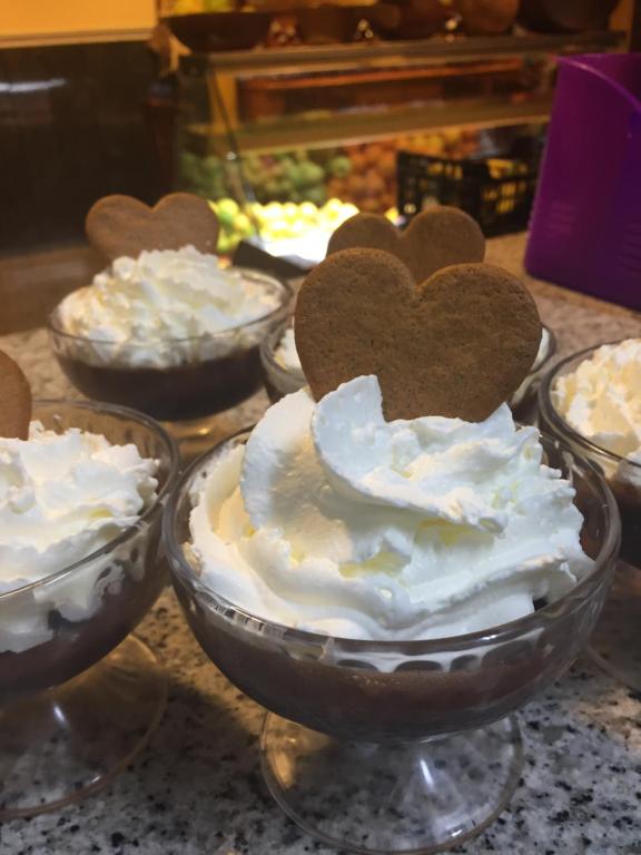 a group of desserts in glass bowls on a counter at Hotel Sonia Chipude in El Cercado