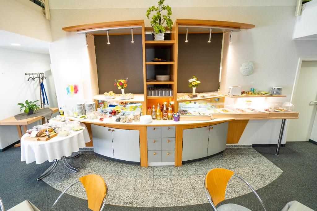 a room with a table and chairs in a room at Hotel Tanne in Saalfeld