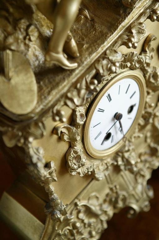 a gold clock sitting on top of a table at Mirador de Dalt Vila-Relais & Chateaux in Ibiza Town