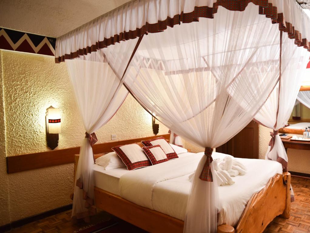Llit o llits en una habitació de Masai Lodge