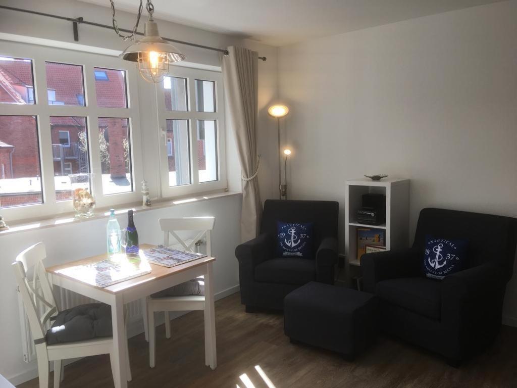 a living room with a table and two chairs at Inselresidenz Strandburg Apartment 209 in Juist