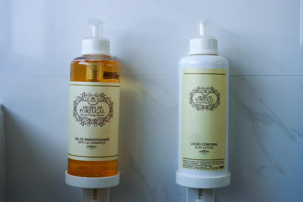 two bottles of soap sitting next to each other at Cascais City & Beach Hotel in Cascais