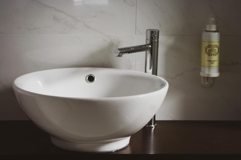 a white sink with a faucet in a bathroom at Cascais City & Beach Hotel in Cascais