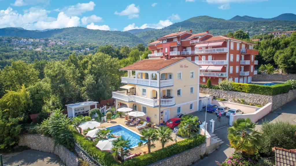 an aerial view of a house with a swimming pool at Apartments Villa Chiara Opatija in Ičići