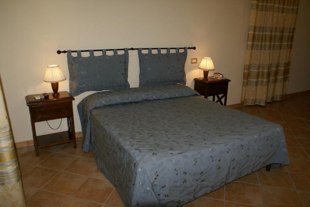 Postel nebo postele na pokoji v ubytování Residence Hotel La Commenda