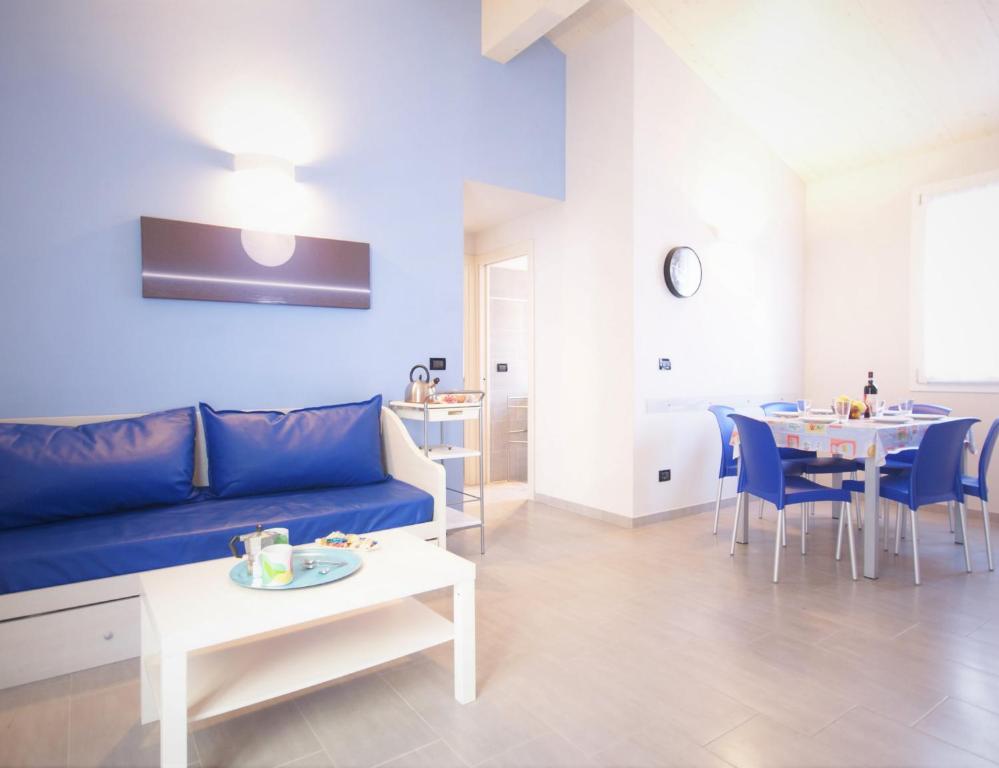 a living room with a blue couch and a table at La Luna Di Bruno in Imperia
