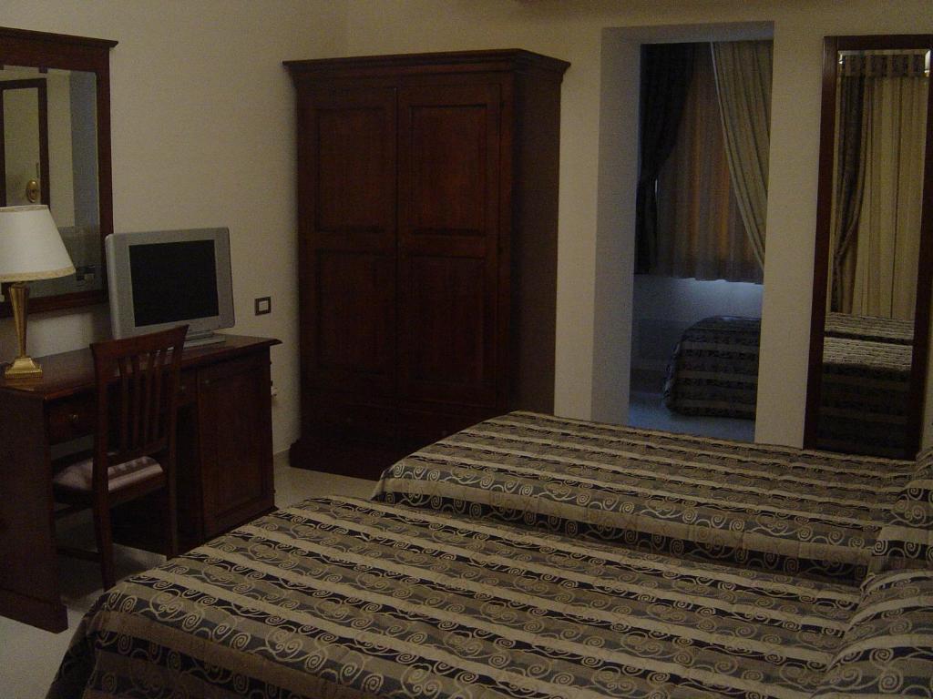 Postel nebo postele na pokoji v ubytování Hotel Domus