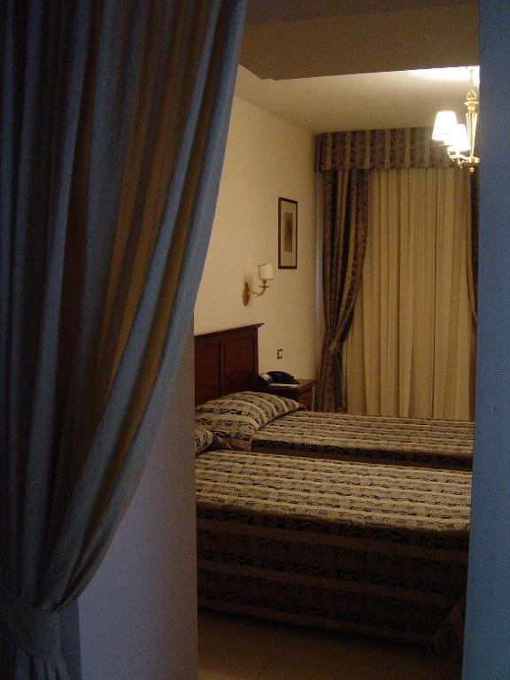 Postel nebo postele na pokoji v ubytování Hotel Domus