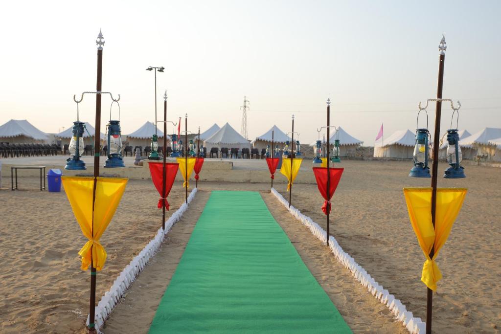 a path on the beach with a green and yellow at Bhati Desert Camp Sam in Jaisalmer