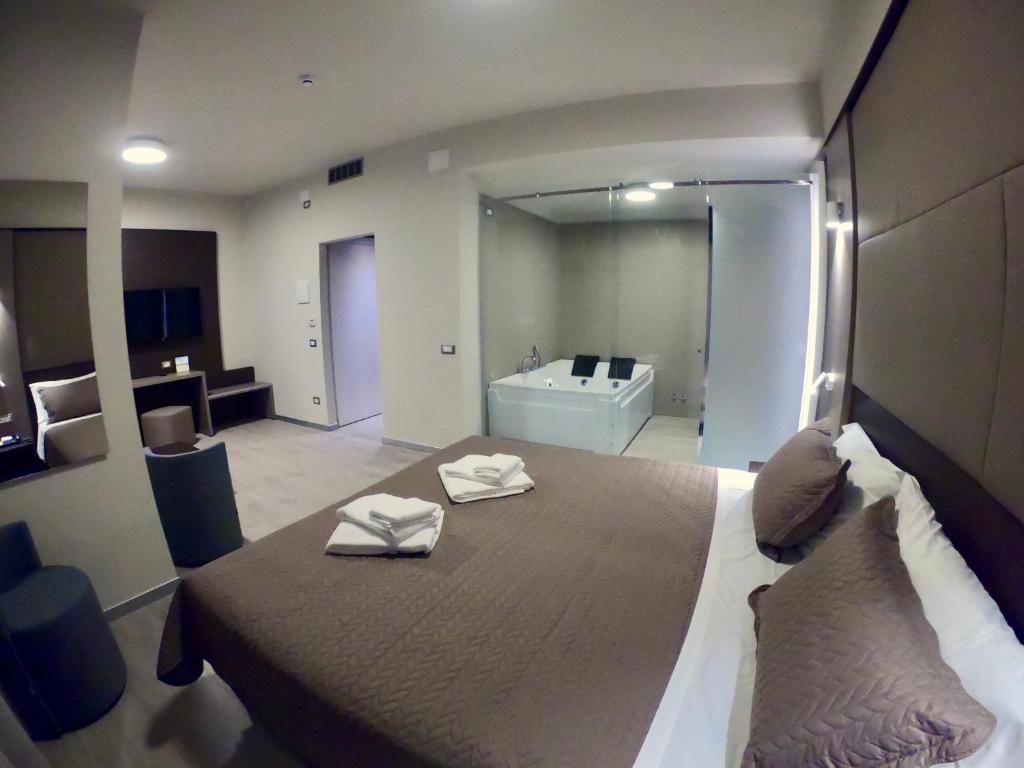 Postel nebo postele na pokoji v ubytování Hotel Santin