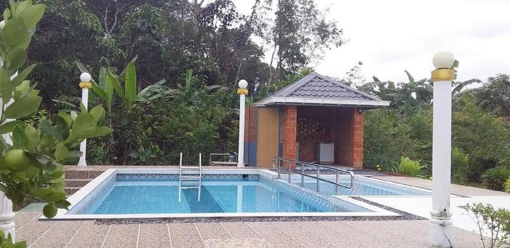 a swimming pool in front of a house at Seri Kenangan in Kota Samarahan