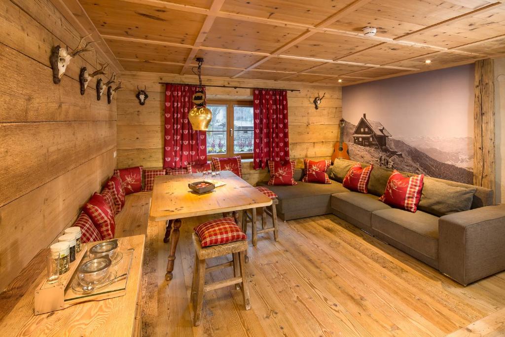 a living room with a couch and a table at Hundehotel Riederhof in Ried im Oberinntal