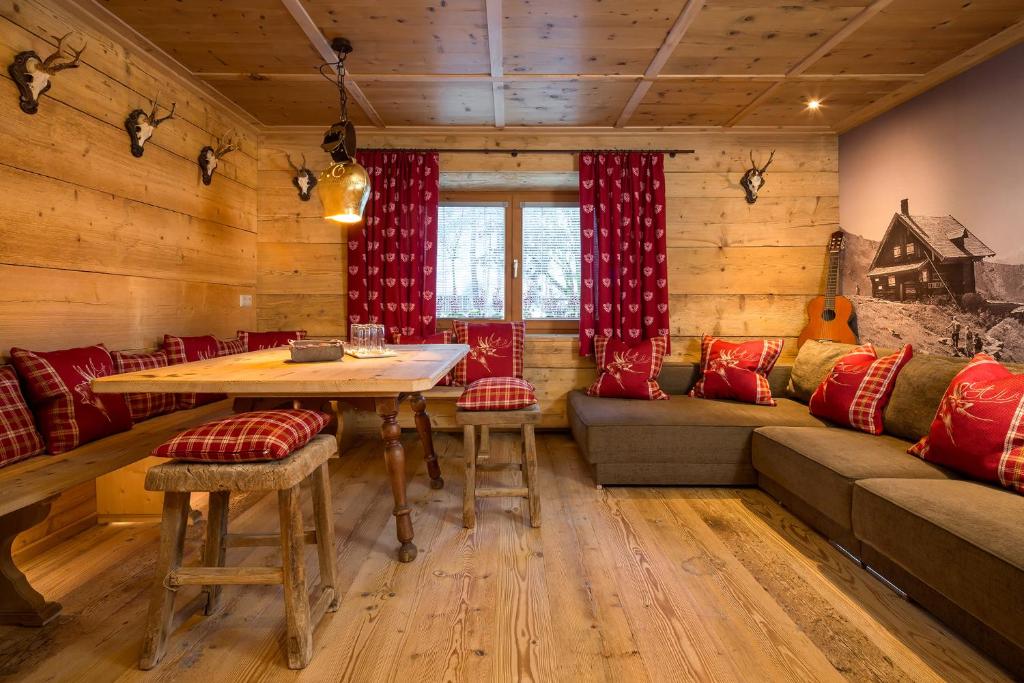 a living room with a table and a couch at Hundehotel Riederhof in Ried im Oberinntal