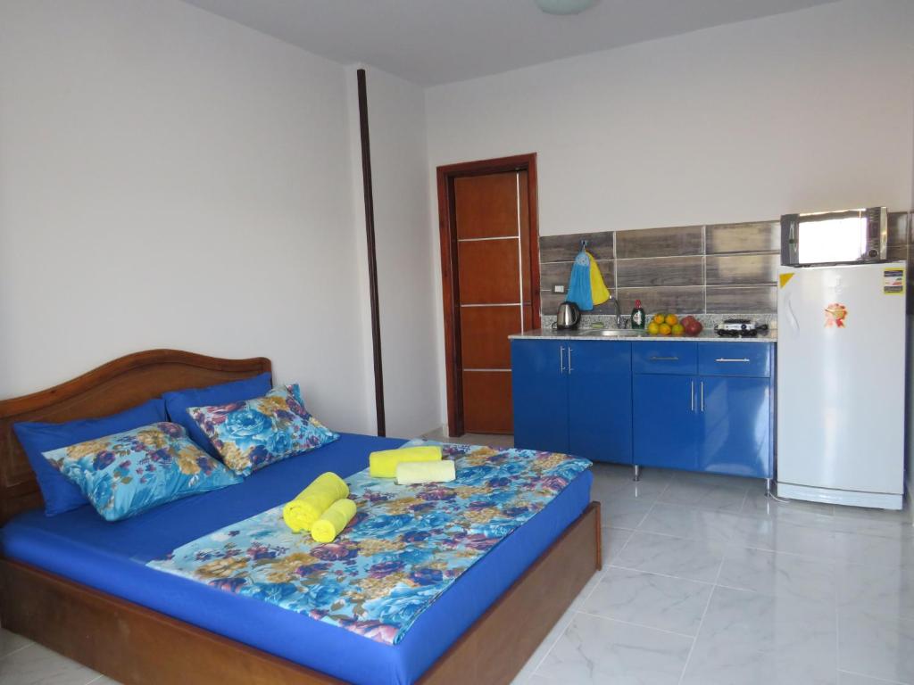 a bedroom with a blue bed and a refrigerator at Apartment Stella di Mari near the sea RedSeaLine in Hurghada