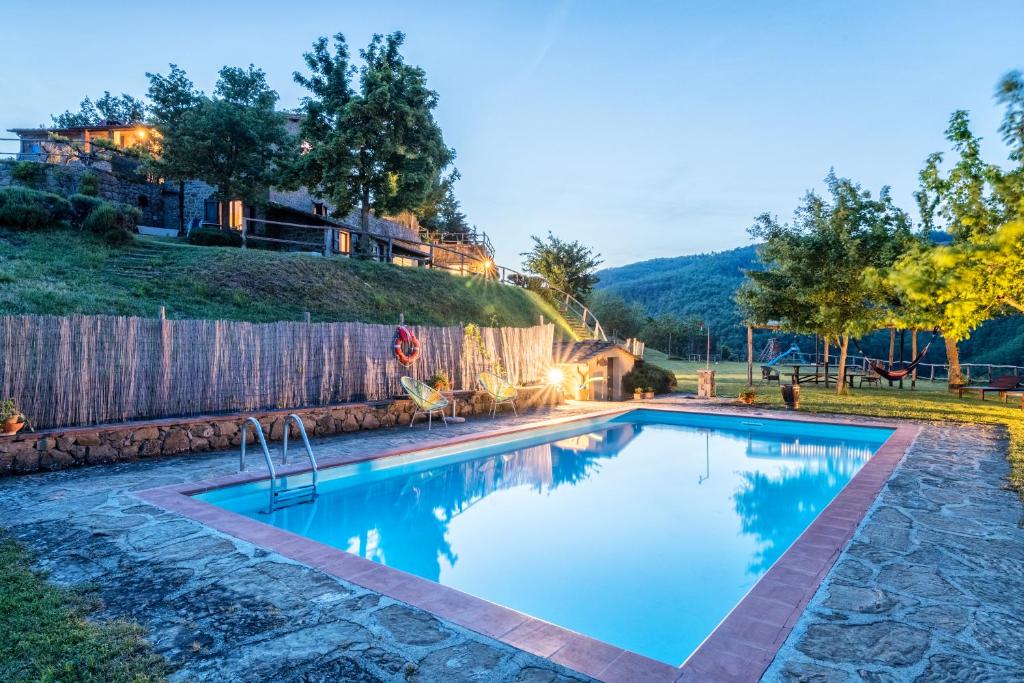 a swimming pool in the yard of a house at Agriturismo La Sala in Greve in Chianti