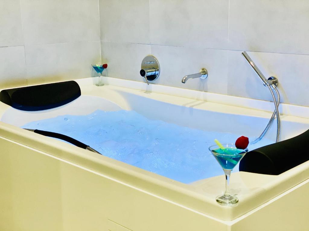 a bath tub filled with blue water with a drink in it at Canaryislandshost l Brisa del Atlántico in Playa Honda