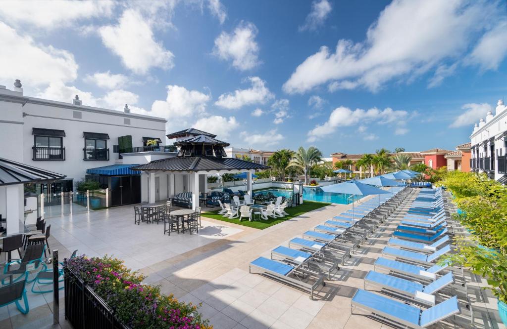 an outdoor patio with lounge chairs and a pool at Inn On Fifth in Naples