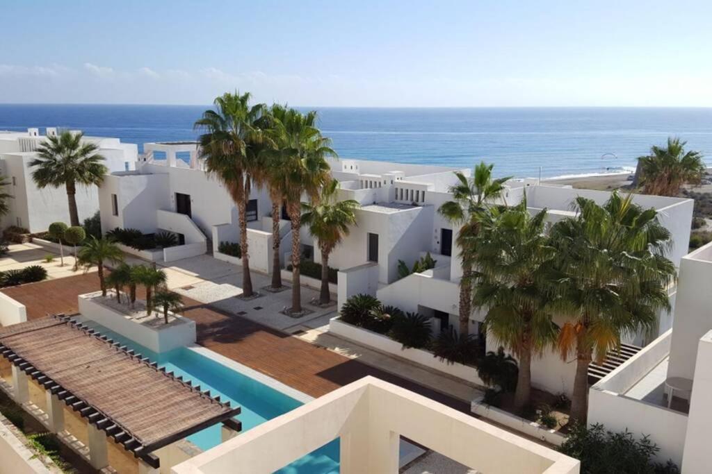 an aerial view of a resort with a swimming pool and the ocean at Macenas Beach Resort Mojacar -Almeria in Mojácar