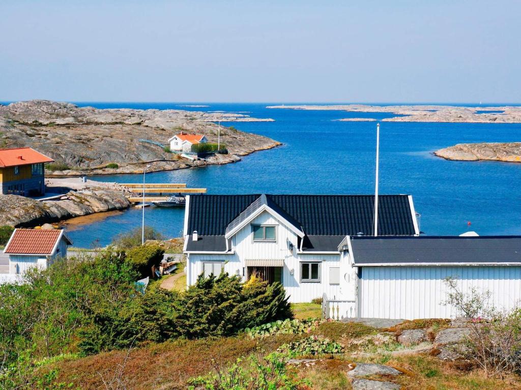 a house on a hill next to the water at 2 person holiday home in V JERN in Väjern