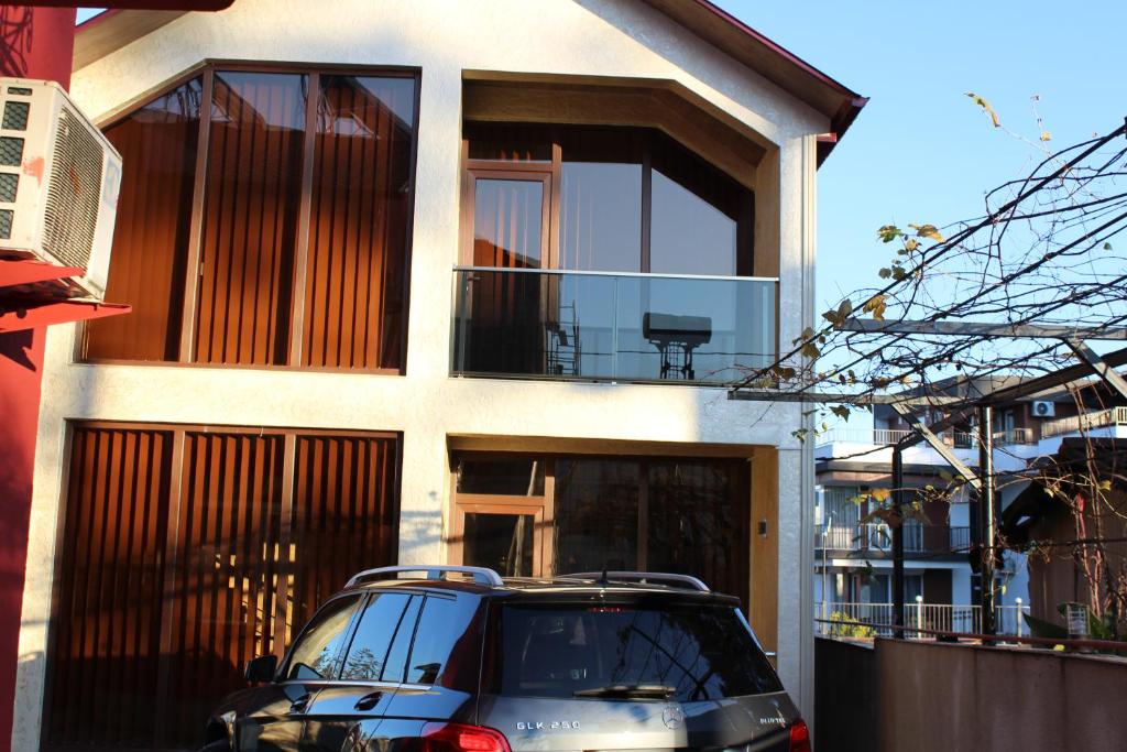 a black suv parked in front of a house at KOTEJ UREKI in Ureki