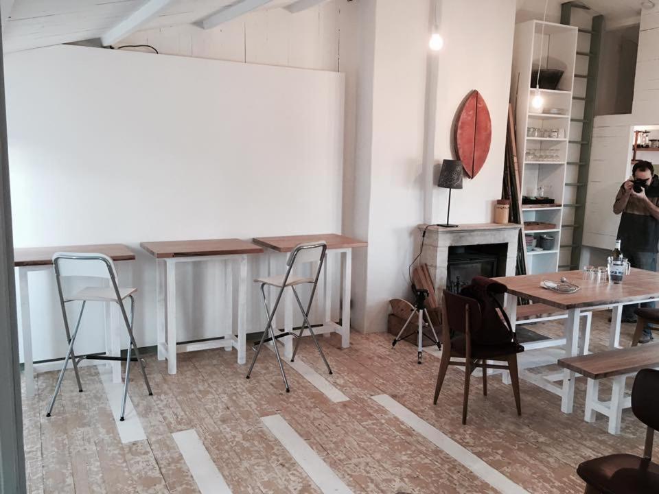 a room with chairs and a table and a fireplace at Logement Design à Loix-en-Ré - 2 étoiles - Centre Village in Loix