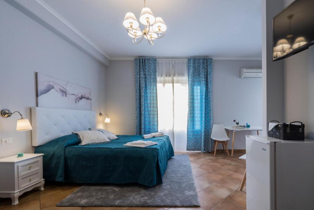 a bedroom with a bed and a chandelier at Domus Prati in Rome