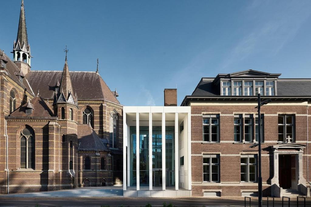 a large brick building with a clock on the front of it at Hotel Mariënhage in Eindhoven