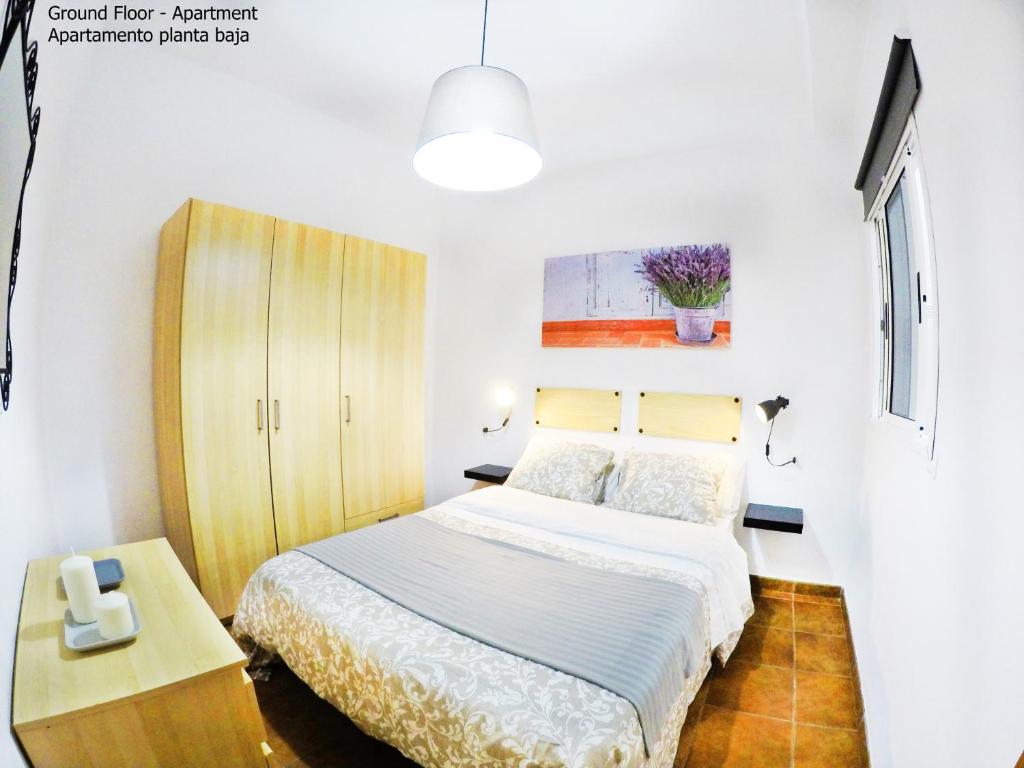 a bedroom with a bed and a wooden cabinet at Apartamentos Ester in Santa Cruz de Tenerife